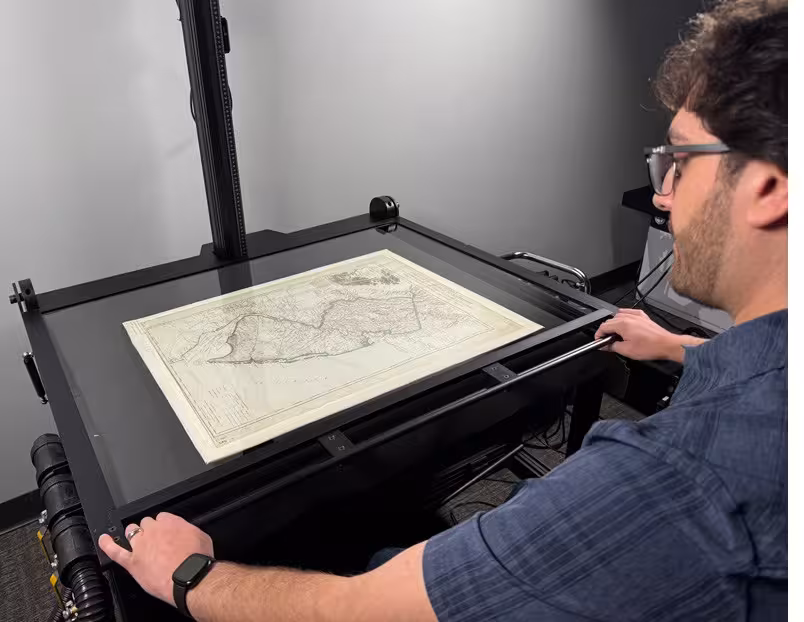 Technician scanning archived paper records